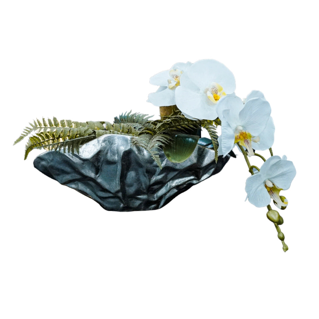 Decorative vase with white flowers and green leaves on a white background