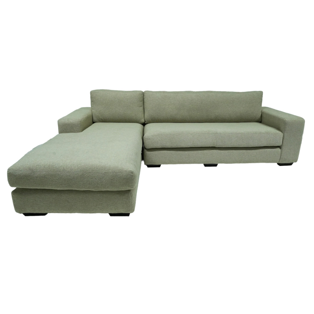 Green sectional sofa on a white background