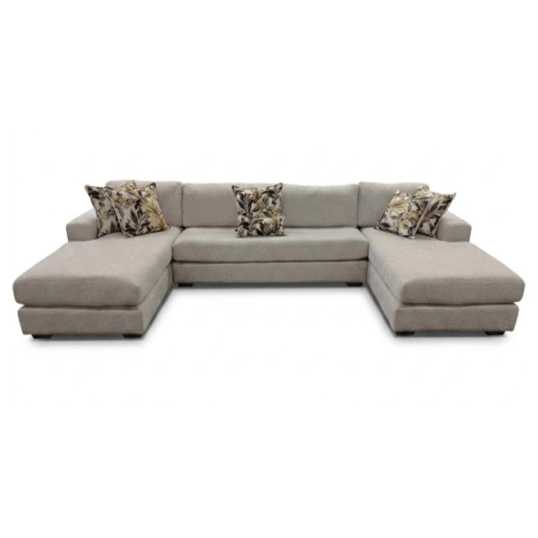 Gray sectional sofa with patterned cushions on a white background