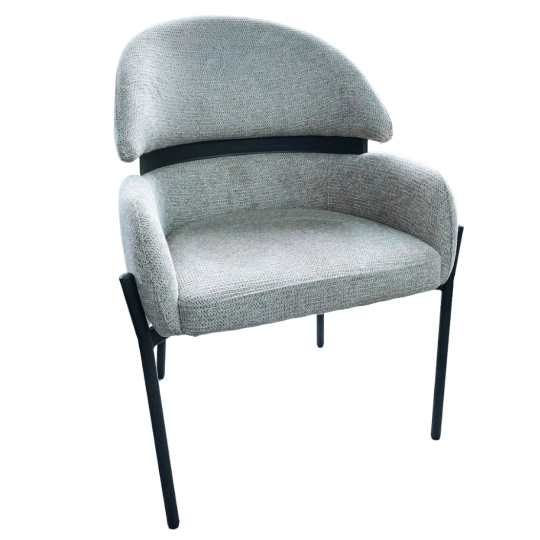 Beige upholstered chair with black metal legs on a white background