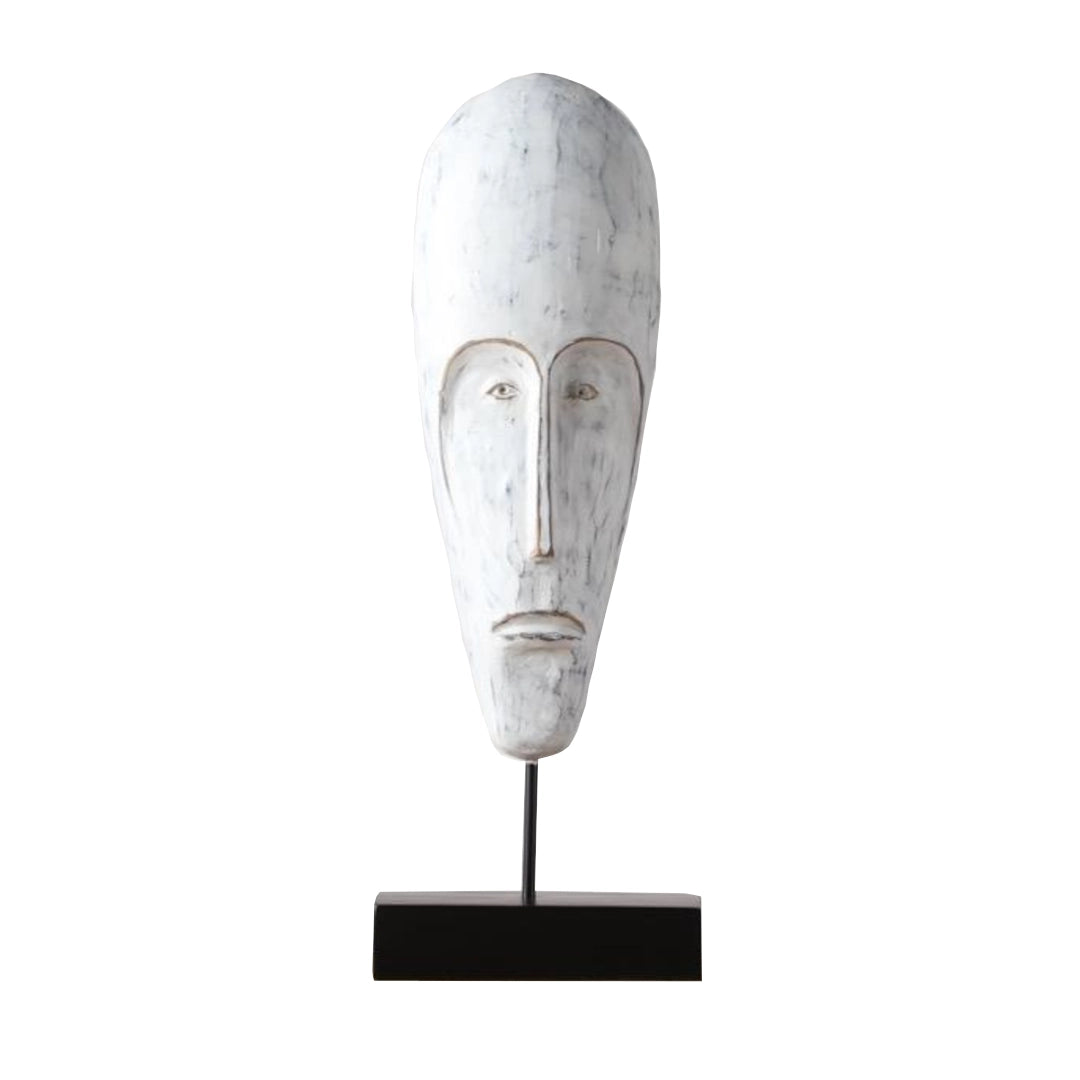 White abstract polyresin face sculpture on a black stand against a white background