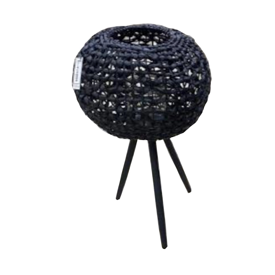 Black woven basket with a glass pot and three legs on a white background