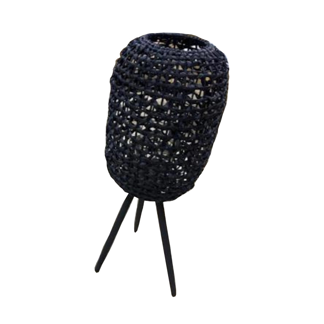 Black woven oblong basket with tripod base on a white background