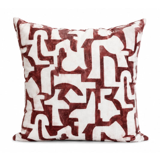 Decorative pillow with red and white abstract pattern on a white background