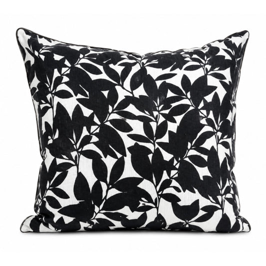 Black leaf patterned pillow on a white background