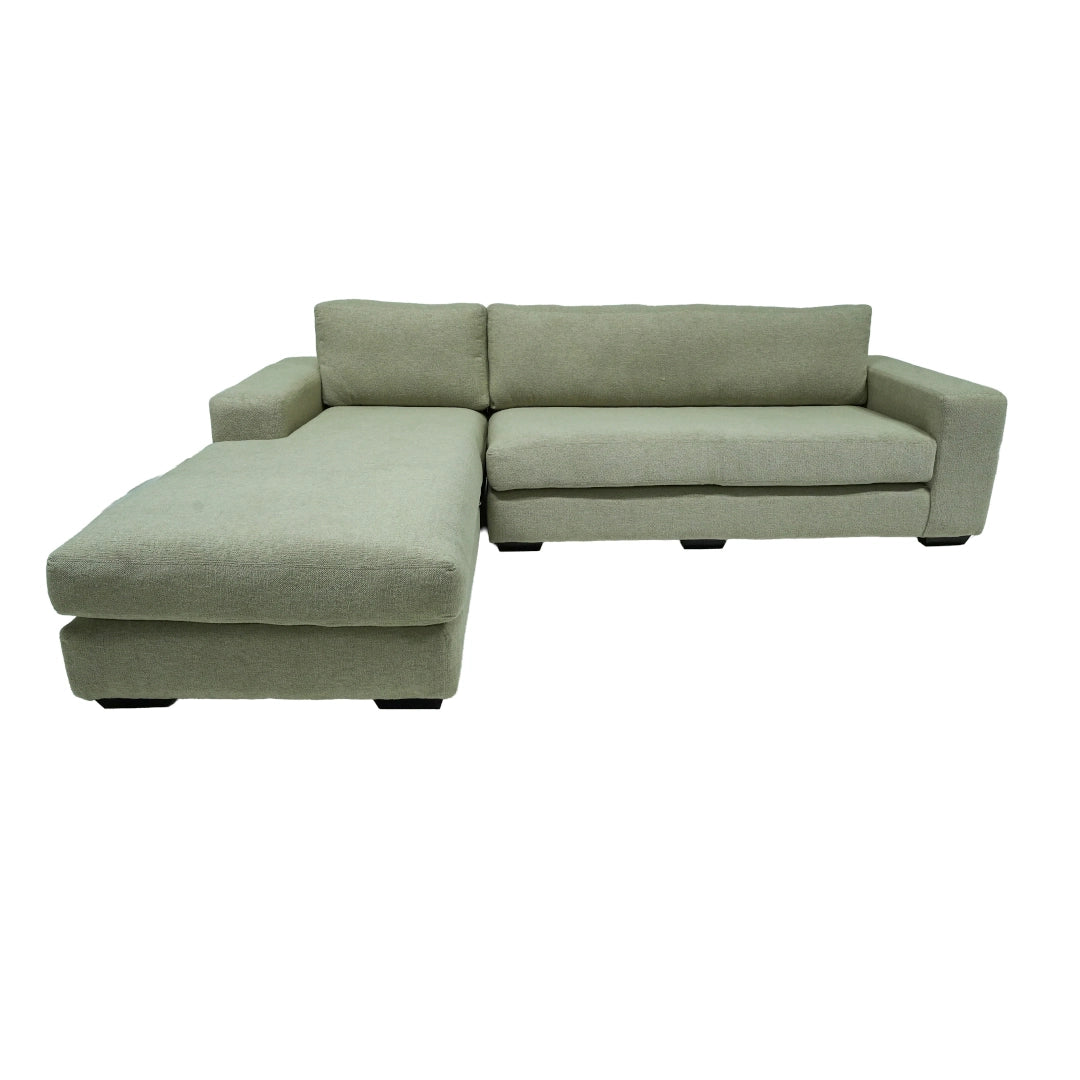 Green sectional sofa on a white background