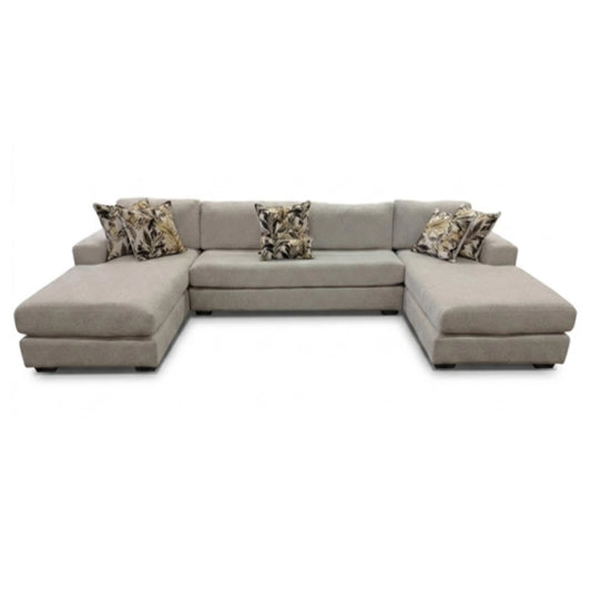 Gray sectional sofa with patterned cushions on a white background