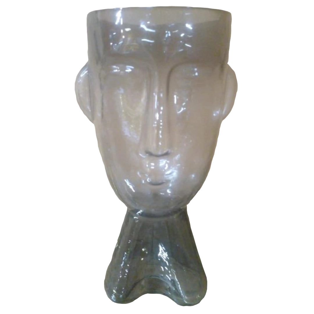A Grey glass vase shaped like a face on a white background