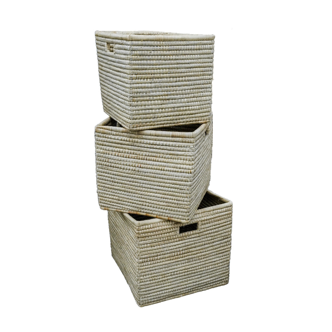 Set of three woven laundry baskets on a white background