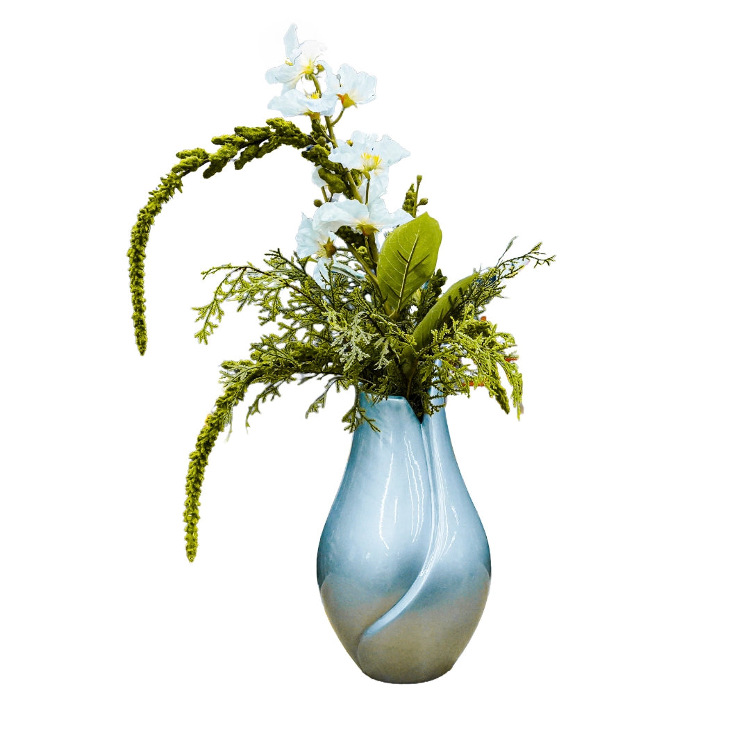Decorative vase with greenery and white flowers on a white background