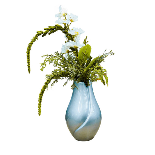 Decorative vase with greenery and white flowers on a white background