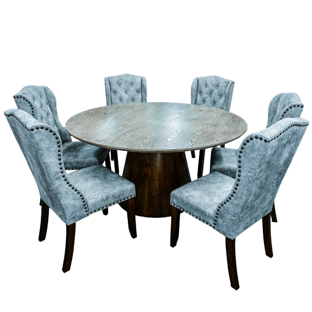 Round dining table with six tufted chairs on a white background