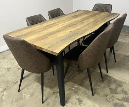 Dining table set with six chairs in a room with a light-colored floor.