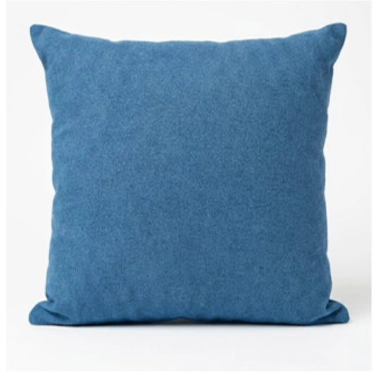 A blue scatter cushion on a white background