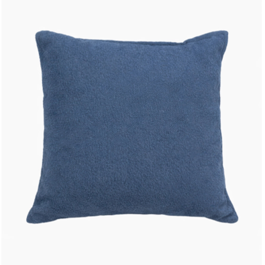 A blue scatter cushion on a white background