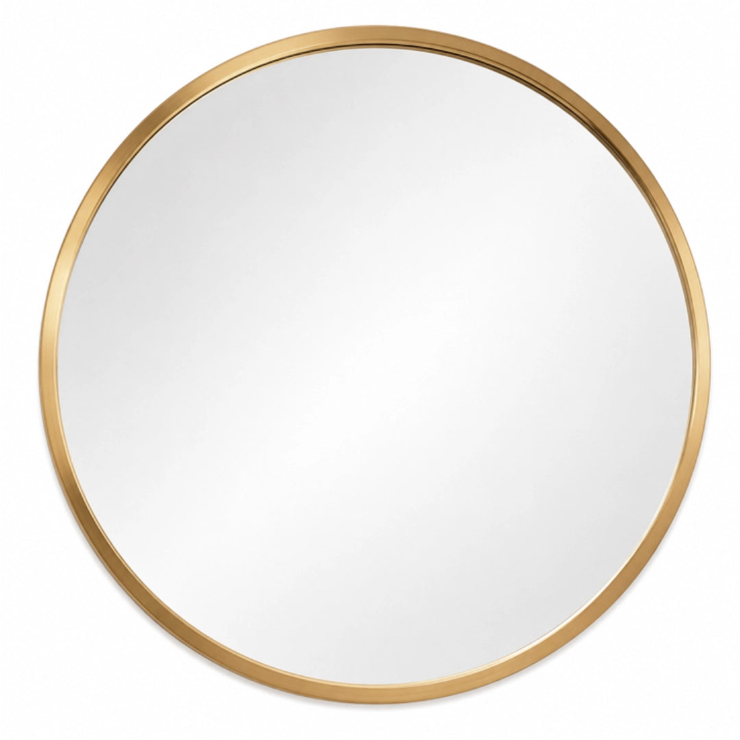 A round mirror with a gold frame on a white background