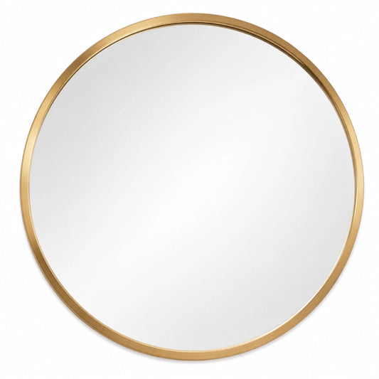 A round mirror with a gold frame on a white background