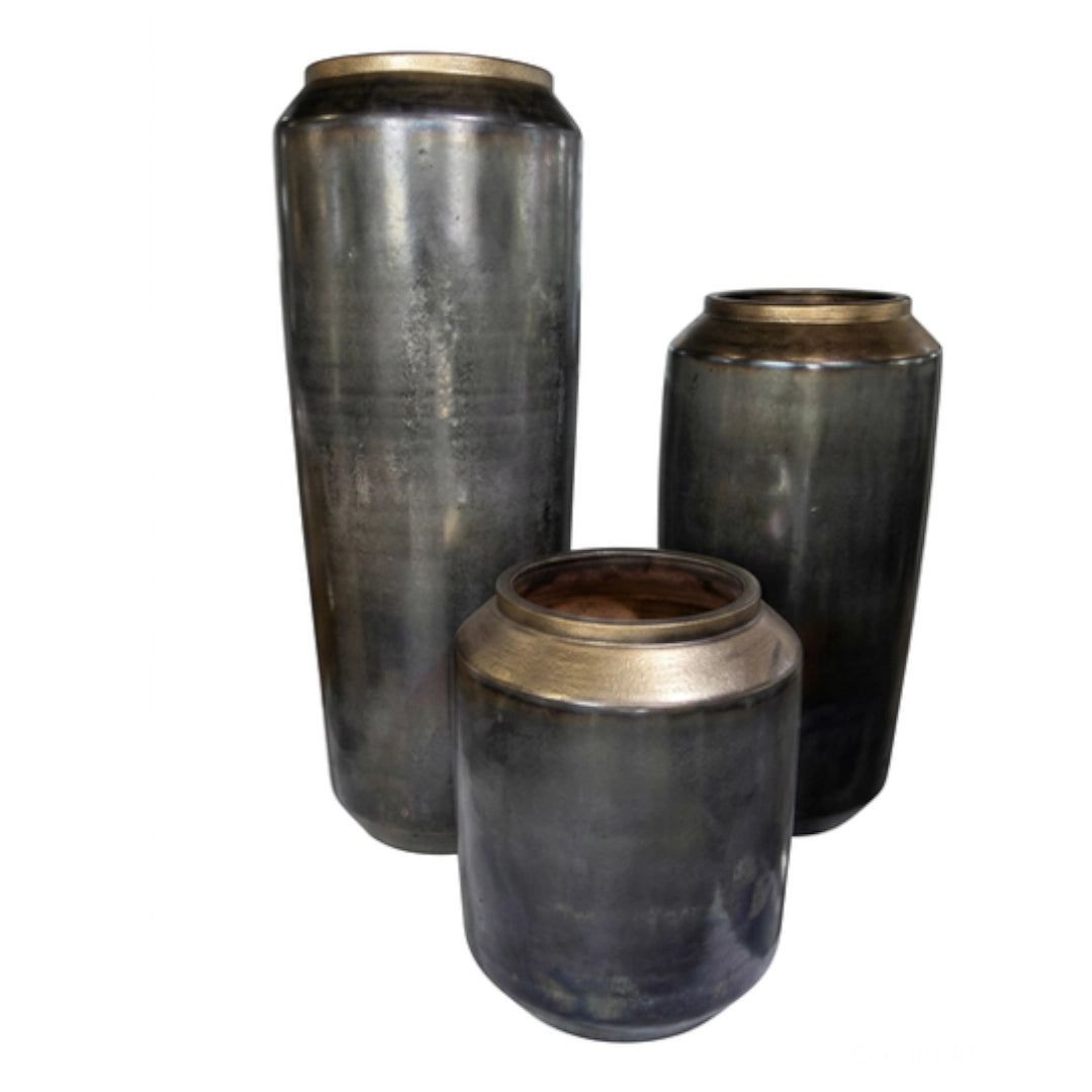 A set of metallic pots on a white background