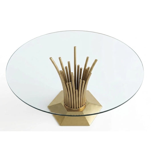 A gold and glass table on a white background