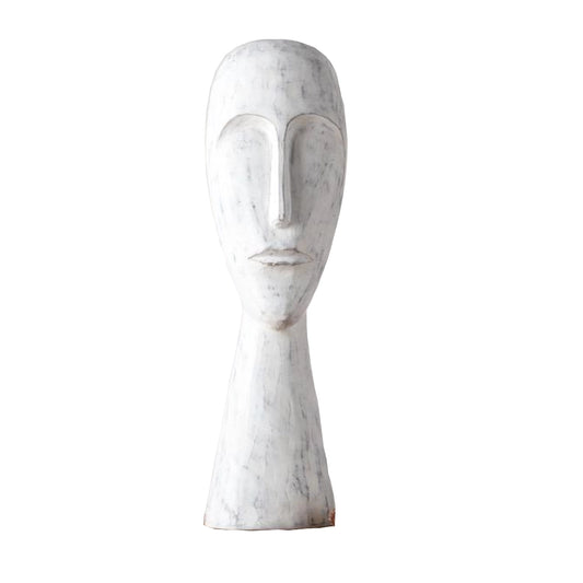 White polyresin sculpture of a face on a white background