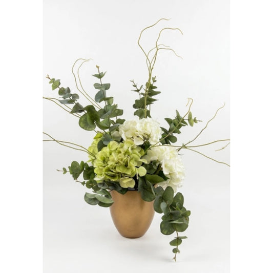 An artificial floral arrangement featuring white roses, light green hydrangeas, eucalyptus leaves, and delicate bare stems in a small metallic gold vase, set against a plain white background.