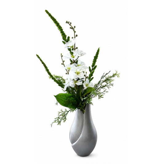 A modern gray ceramic vase with a sculptural, curved form holding a floral arrangement of white flowers and green foliage, set against a plain white background.