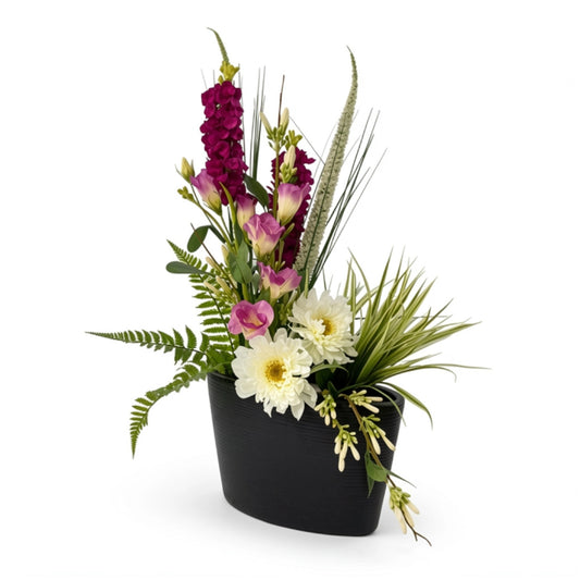 A black vase with flowers on a white background