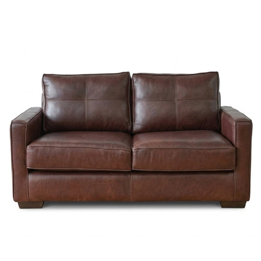 A brown leather sofa on a white background