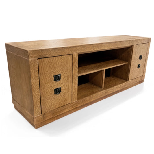 A wooden TV stand or media console with a warm oak finish, featuring two cabinet doors with black metal handles on the sides and an open center shelf.